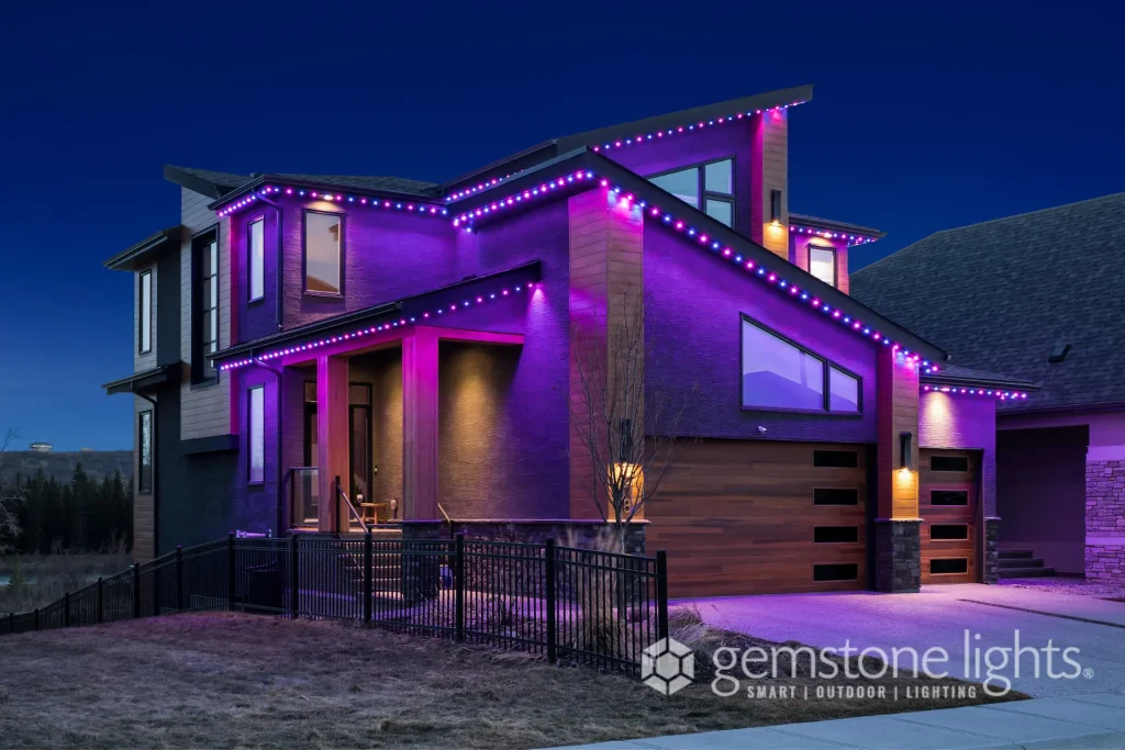 A modern house illuminated with vibrant purple lights at twilight
