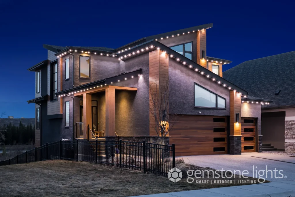A modern home is showcased with decorative string lighting against a twilight sky