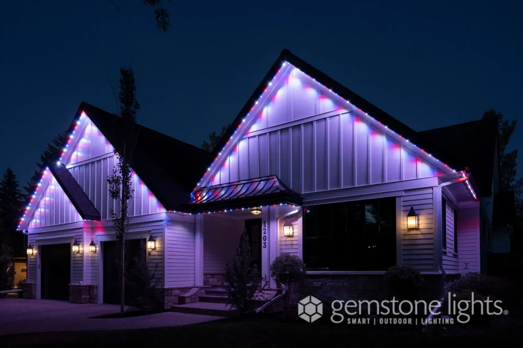 A house is adorned with vibrant purple and red lights at night