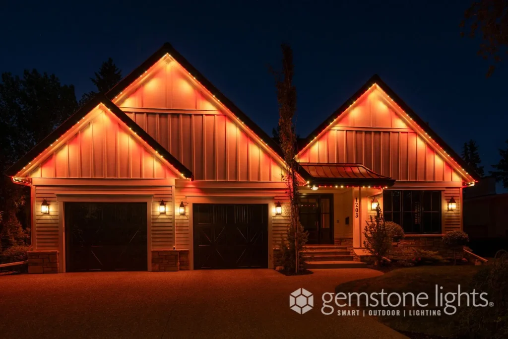 A well-lit house with vibrant orange lights illuminating its exterior at night