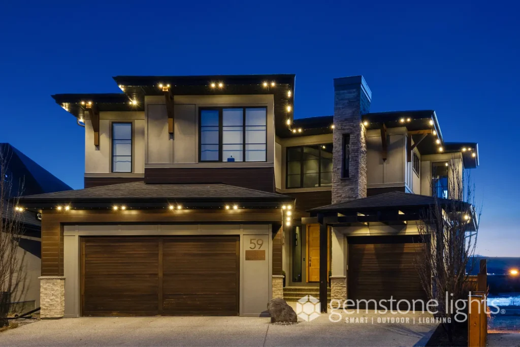 A modern home glows with decorative lights against a twilight sky