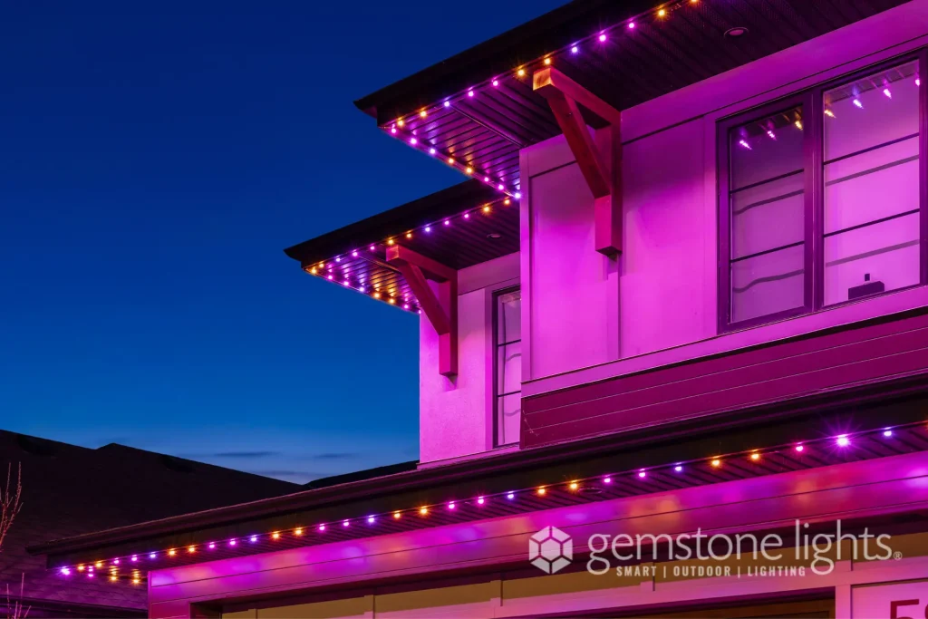 Vibrant purple lights illuminate the eaves of a modern house at dusk