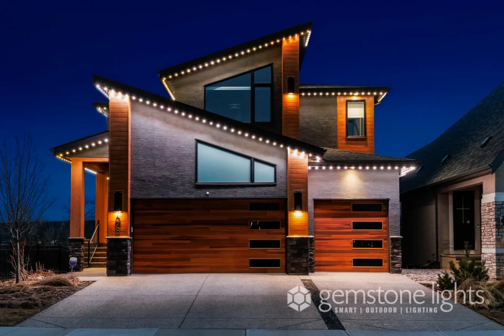 A modern house features illuminated architectural details against a twilight backdrop