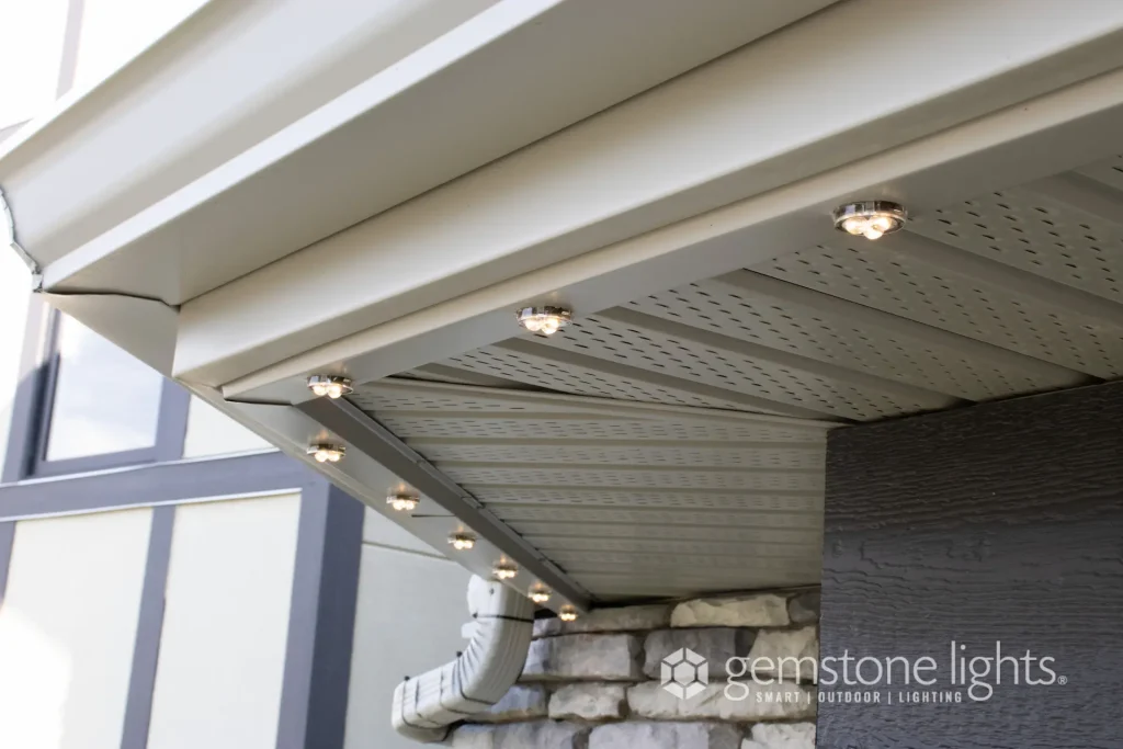 Warm white lights are installed under the eaves of a house