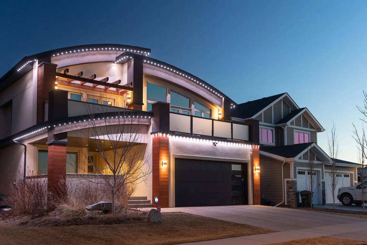 A stylish house is illuminated with decorative lights during twilight